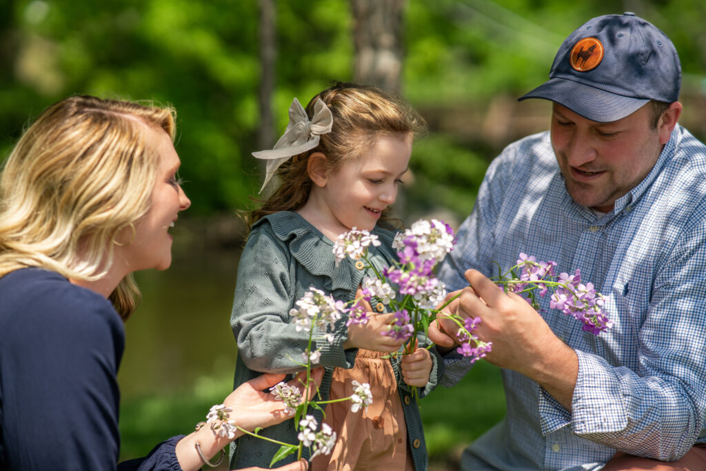 candid photos of family smelling the flowers